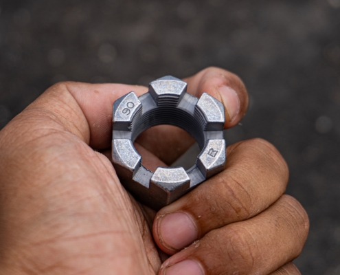 Close Up Of A Rugged Castle Nut Held By A Technician