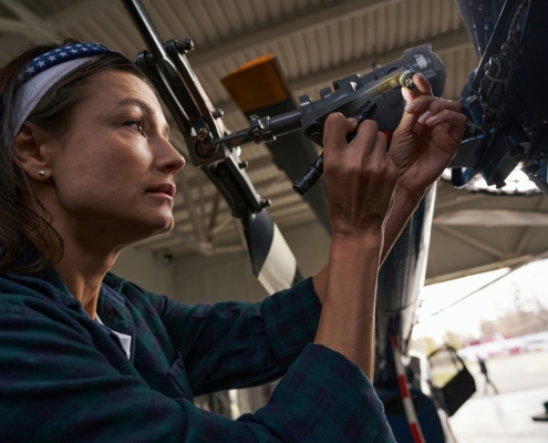 Worker Measuring Parts On Plane