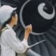 Side View Of Aerospace Inspector Standing Next To Large Turbine